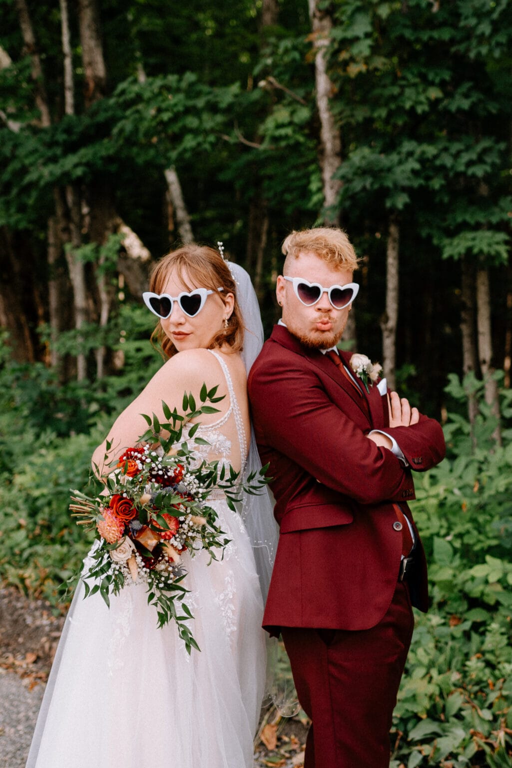 Just married couple wearing heart sunglasses strikes a fun pose for Toronto Wedding Photographer. 