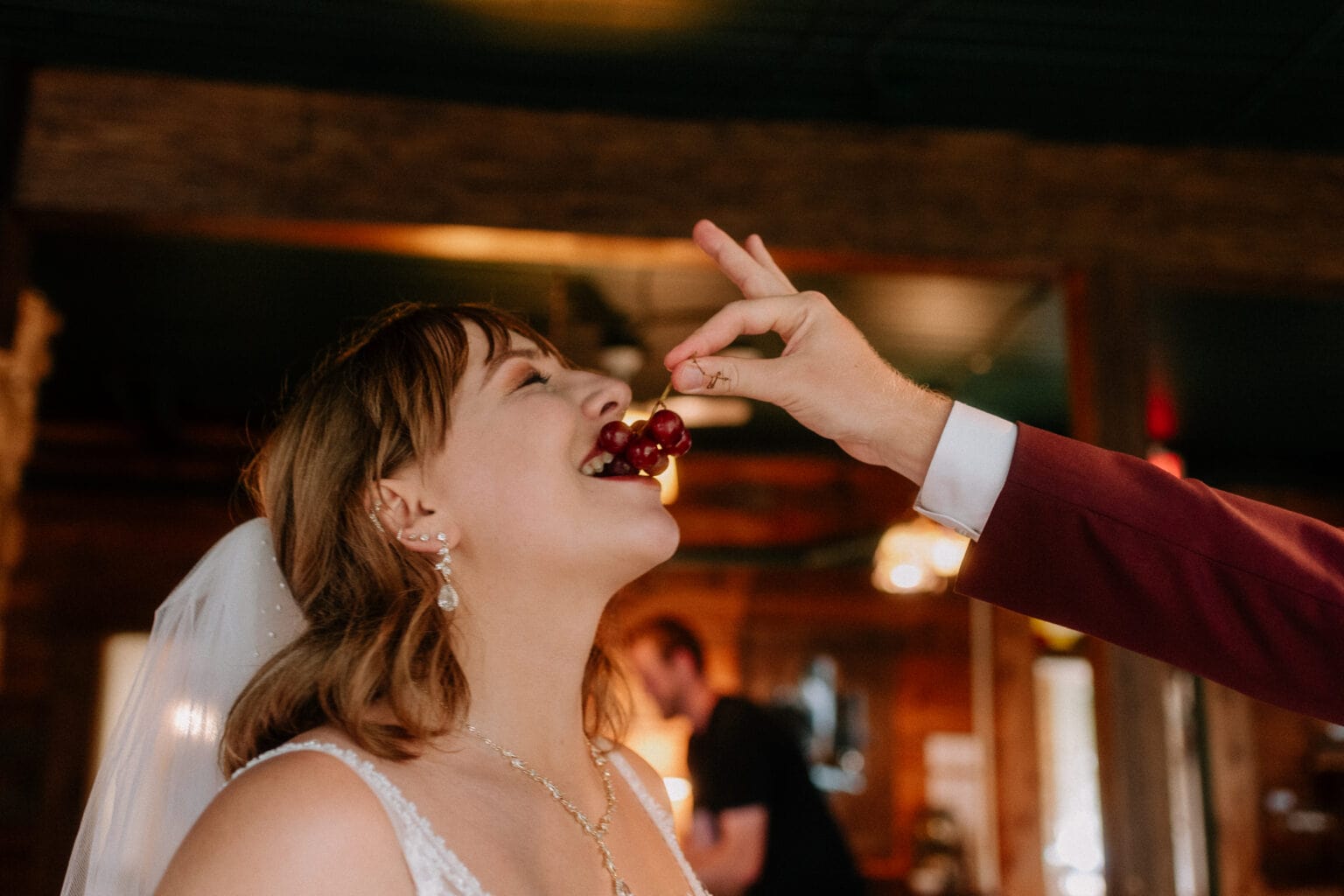 Bride getting fed grapes by groom as Toronto wedding photographer captures this fleeting moment.